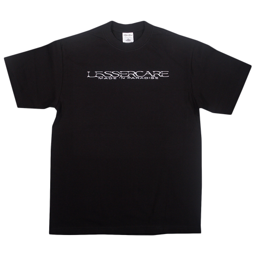 Black Shakawear I’M TRYING (Single Release) short-sleeved t-shirt with white text across the chest that reads LESSERCARE above MADE IN PARADISE.
