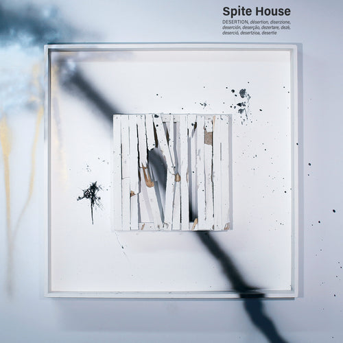 Desertion is a square white frame with broken wooden planks arranged vertically, splattered in black and gray paint. The upper right corner displays "Spite House," definitions of desertion in various languages, and post-hardcore references.