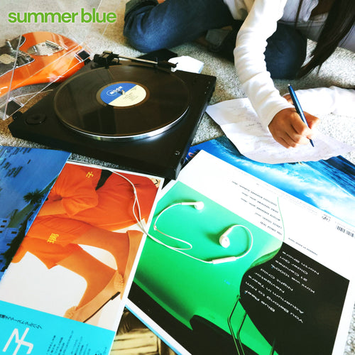 A person writes on paper next to a spinning record player, colorful album covers, and white earphones. “Summer Blue” appears in green and blue at the top left, referencing the Summer Blue EP by San Jose’s power pop band.